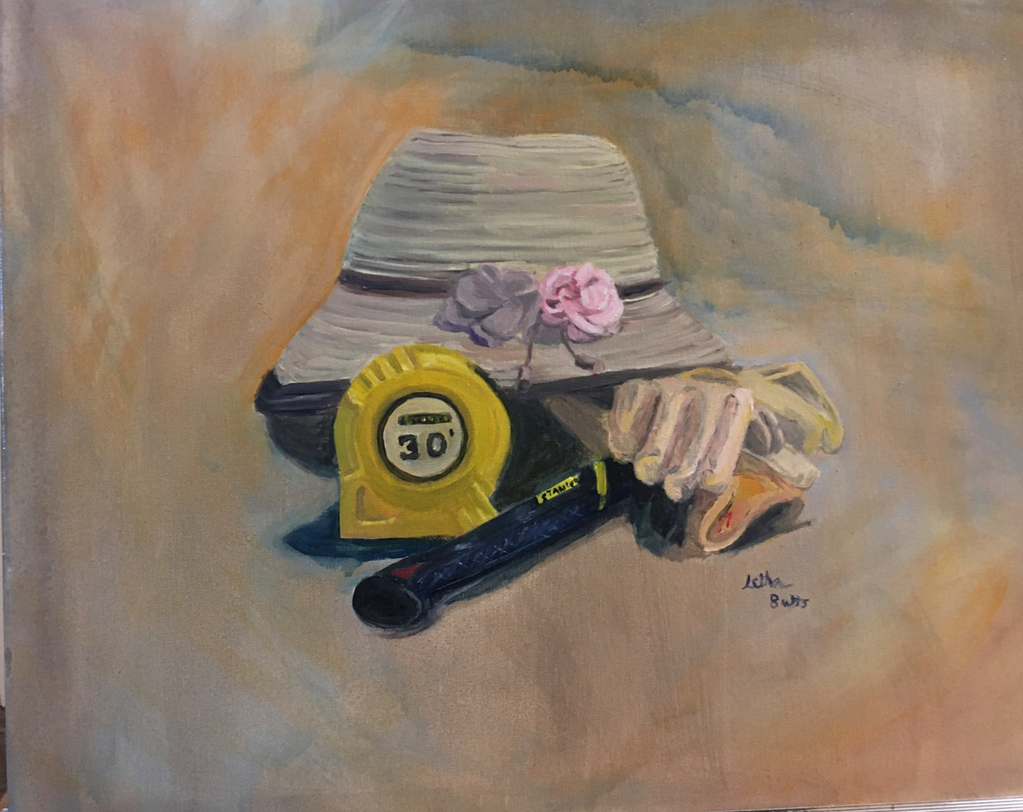 a woman's straw hat with two flowers, one brown, one pink. A pair of work gloves, a hammer, and a 30' tape measure.